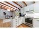 Open kitchen with white cabinets, stainless appliances, and an island with granite countertops at 1890 Silvastone Dr, Decatur, GA 30033