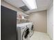 Efficient laundry room with white washer and dryer set, plus shelving for storage at 1890 Silvastone Dr, Decatur, GA 30033