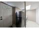 Functional laundry area with white door and modern stainless steel refrigerator at 1890 Silvastone Dr, Decatur, GA 30033