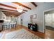 Open-concept living space with hardwood floors, wood beam ceilings, and a view of the kitchen at 1890 Silvastone Dr, Decatur, GA 30033