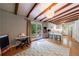 Open-concept living space with hardwood floors, wood beam ceilings, and access to the back yard at 1890 Silvastone Dr, Decatur, GA 30033