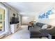 Spacious living room with hardwood flooring, a cozy sectional, and abundant natural light at 1890 Silvastone Dr, Decatur, GA 30033