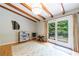 Open-concept living space with hardwood floors, wood beam ceilings, and access to the back yard at 1890 Silvastone Dr, Decatur, GA 30033