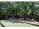 Backyard playground with wooden swing set and slide, perfect for Gathering fun at 1890 Silvastone Dr, Decatur, GA 30033