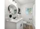 Well-lit bathroom with modern fixtures, round mirror, and neutral tones, providing a spa-like feel at 2376 Cross Nw St, Atlanta, GA 30318