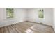 Inviting bedroom filled with light from two windows, showcasing wood-look floors and fresh decor at 2376 Cross Nw St, Atlanta, GA 30318
