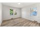 Bright bedroom features two windows and clean wood-look floors, creating a serene atmosphere at 2376 Cross Nw St, Atlanta, GA 30318