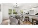 Bright dining area seamlessly connected to kitchen, featuring a stylish table and seating with modern chandelier at 2376 Cross Nw St, Atlanta, GA 30318