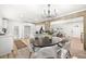 Bright dining area next to kitchen and living area, featuring hardwood floors, and modern chandelier at 2376 Cross Nw St, Atlanta, GA 30318