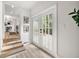 Welcoming entryway with wood-look floors, glass doors, and steps leading to a dining and kitchen area at 2376 Cross Nw St, Atlanta, GA 30318