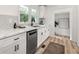 Stylish kitchen featuring white cabinets, granite countertops, stainless steel appliances, and hardwood style flooring at 2376 Cross Nw St, Atlanta, GA 30318