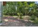 Lush backyard, perfect for gardening and outdoor activities, bordered by dense, mature trees at 3189 Glen Hollow Dr, Rex, GA 30273