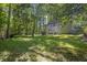 Expansive backyard with mature trees offering shade and privacy, perfect for outdoor activities and relaxation at 3189 Glen Hollow Dr, Rex, GA 30273