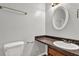 Bathroom featuring a vanity with granite countertop, decorative mirror, and toilet at 3189 Glen Hollow Dr, Rex, GA 30273