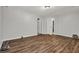 Spacious bedroom with wood-look floors, neutral walls, and ample closet space, offering a modern and functional design at 3189 Glen Hollow Dr, Rex, GA 30273