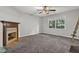 Cozy bedroom featuring a decorative fireplace with carpet floors and a large window, offering plenty of natural light at 3189 Glen Hollow Dr, Rex, GA 30273