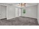 Bedroom features neutral walls, carpet flooring, ceiling fan, closet doors, and window at 3189 Glen Hollow Dr, Rex, GA 30273