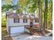 Charming split-level home featuring a garage, brick accents, and a wooded lot at 3189 Glen Hollow Dr, Rex, GA 30273