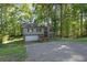 Charming split-level home with a brick and gray facade nestled amongst mature trees on a sunny day at 3189 Glen Hollow Dr, Rex, GA 30273