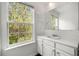 Bathroom with a large window view, white cabinets, sink and a large mirror at 6750 Blackstone Pl # 6, Mableton, GA 30126