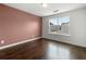 This bedroom features hardwood floors, a window and views of the nearby neighborhood at 6750 Blackstone Pl # 6, Mableton, GA 30126