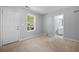 This bedroom features a door to a bathroom and a view of a wooded area at 6750 Blackstone Pl # 6, Mableton, GA 30126