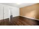 This large bedroom is painted with white and tan paint and has hardwood floors at 6750 Blackstone Pl # 6, Mableton, GA 30126