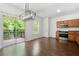 Open dining room featuring hardwood floors, natural light, and backyard deck access at 6750 Blackstone Pl # 6, Mableton, GA 30126