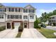 A daytime exterior view of townhomes, each with a private garage and manicured landscaping at 6750 Blackstone Pl # 6, Mableton, GA 30126