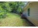 View of the home's backyard featuring a grassy area with mature trees and an AC unit at 1808 Arkose Se Dr, Atlanta, GA 30316