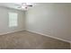 Bright bedroom features a ceiling fan and neutral carpeting at 1808 Arkose Se Dr, Atlanta, GA 30316