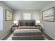 A staged bedroom featuring two pieces of art, a window, and new carpet at 1808 Arkose Se Dr, Atlanta, GA 30316