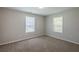 A light-filled bedroom with two large windows and new carpet at 1808 Arkose Se Dr, Atlanta, GA 30316
