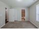 A carpeted bedroom that features a pair of closets and access to the bathroom at 1808 Arkose Se Dr, Atlanta, GA 30316