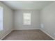 A bright bedroom with a window, new flooring, and neutral paint at 1808 Arkose Se Dr, Atlanta, GA 30316