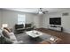 Staged living room featuring new paint, stylish ceiling fan, and beautiful wood-look floors at 1808 Arkose Se Dr, Atlanta, GA 30316
