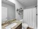 Well-lit bathroom featuring a granite vanity and a shower with curtain at 201 Kingfisher Walk, Covington, GA 30014