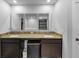 Bathroom featuring double vanity with granite countertop, modern sinks, and dark cabinetry at 201 Kingfisher Walk, Covington, GA 30014