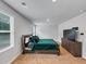Bright bedroom featuring a queen bed, large dresser with TV, and plush carpet at 201 Kingfisher Walk, Covington, GA 30014