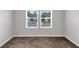 Empty bedroom with neutral carpeting and two sunny windows at 201 Kingfisher Walk, Covington, GA 30014
