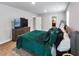 Bright bedroom featuring a queen bed, large dresser with TV, and plush carpet at 201 Kingfisher Walk, Covington, GA 30014