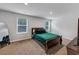 Bedroom featuring a large bed with an emerald quilt and two sunny windows at 201 Kingfisher Walk, Covington, GA 30014