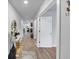 Hallway showcasing sleek wood floors and stylish, modern decor with a view to the kitchen at 201 Kingfisher Walk, Covington, GA 30014