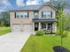 Charming two-story brick home featuring a manicured lawn and a welcoming front porch at 201 Kingfisher Walk, Covington, GA 30014
