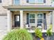 Inviting front porch with seating, a welcome sign and stylish black door at 201 Kingfisher Walk, Covington, GA 30014