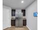 Galley kitchen with stainless steel refrigerator and granite countertops at 201 Kingfisher Walk, Covington, GA 30014