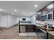 Modern kitchen with stainless appliances and granite countertops, open to the living area at 201 Kingfisher Walk, Covington, GA 30014