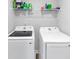 Laundry room with modern, front load washer and dryer at 201 Kingfisher Walk, Covington, GA 30014