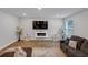 Spacious living room with modern electric fireplace and comfortable seating area at 201 Kingfisher Walk, Covington, GA 30014