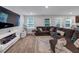 Comfortable living area with a sectional sofa, modern fireplace, and view to outdoor living space at 201 Kingfisher Walk, Covington, GA 30014